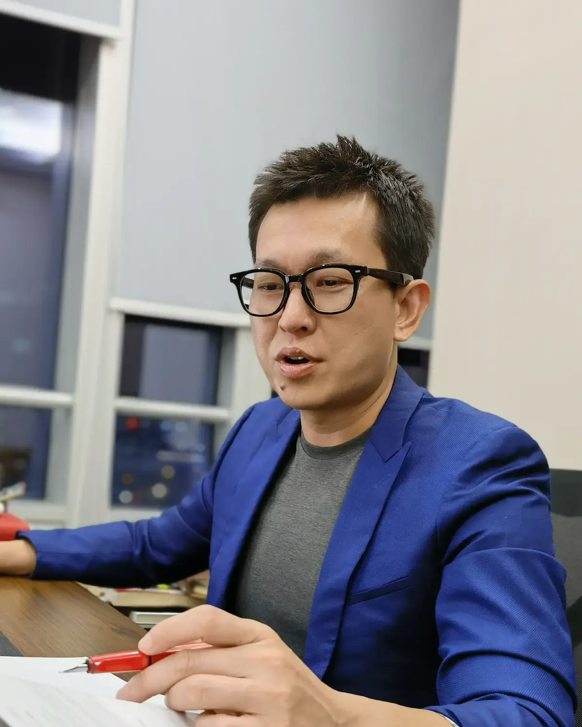 Peter Lin working at his office desk